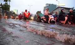 Nước mưa tạo 'sóng' trên phố Sài Gòn