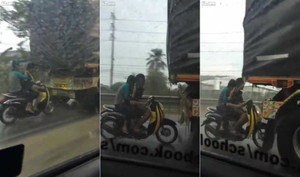 Thót tim cảnh xe máy trú mưa theo phong cách 'thách thức thần chết'