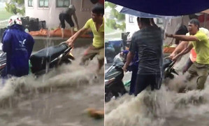 Clip: Nước chảy xiết như lũ, dân vật lộn giữ xe máy trong mưa lớn