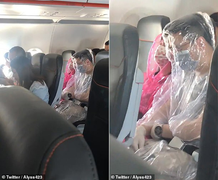 Sợ lây nhiễm Covid-19, cặp đôi mặc áo mưa trong suốt chuyến bay