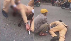Đôi nam nữ đầu trần đi xe máy vượt đèn đỏ, tông gục CSGT ở Hà Nội