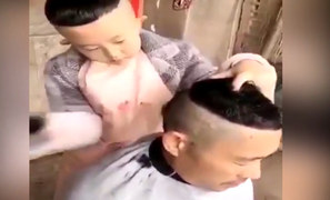 Cậu bé úp bát lên đầu để cắt tóc cho bố