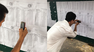 Rưng rưng hình ảnh người cha cặm cụi tìm tên, dò điểm thi của con