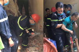 Giải cứu người đàn ông mắc kẹt suốt một đêm trong khe tường hẹp bằng gang tay