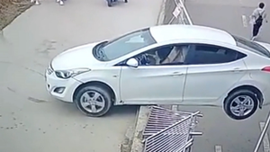 Video: Nữ tài xế lùi xe húc bay hàng rào, treo lơ lửng trên đường