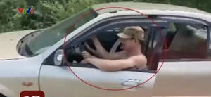 Phạt hai vợ chồng ngồi chung ghế lái ô tô ở Quảng Bình 