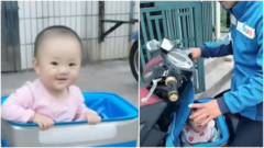 Bé gái ngồi trong hộp giao hàng cùng bố mưu sinh khiến dân mạng thương cảm