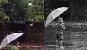 Mất dép, cậu bé đứng thất thần dưới mưa