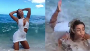 Người đẹp bị sóng quật ngã khi tạo dáng trên bãi biển