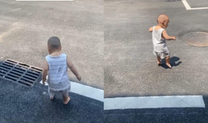 Em bé nhón chân chạy khi thấy mặt đường nóng bỏng