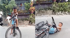 Làm trò trên xe đạp, bé trai ngã ngửa đau điếng