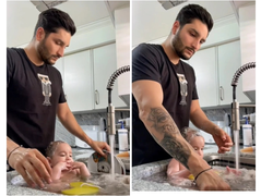 Dân mạng mắng tơi tả ông bố tắm cho con trong bồn rửa bát đang đầy chén đĩa bẩn