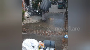 Thùng nước rơi trúng người, người phụ nữ thoát nạn bất ngờ