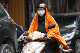 Người Hà Nội mặc áo mưa, trùm chăn ra đường trong ngày rét đỉnh điểm