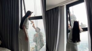Mát lòng cảnh cô gái mời nước anh thợ treo mình giữa trời nóng lau kính cao ốc 
