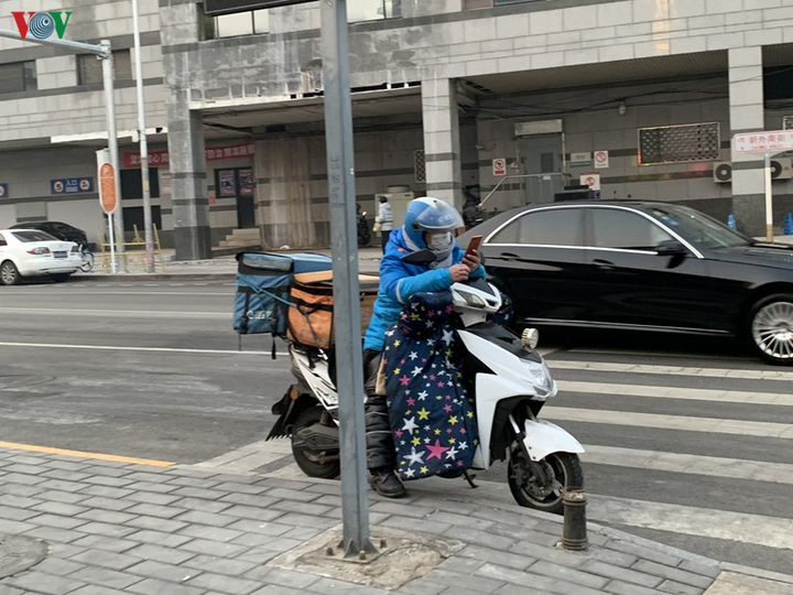 Ảnh: Đường phố Bắc Kinh vắng lặng vì dịch Covid-19 - 18