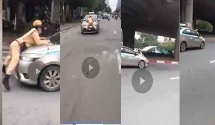Tạm giữ tài xế taxi hất Trung úy CSGT Hà Nội lên nắp capô - 1