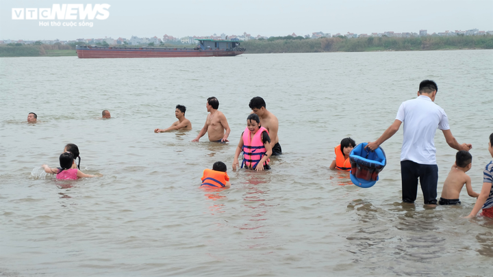 Bất chấp biển cấm, bãi cát ven sông Hồng vẫn đông người tới tắm - 5