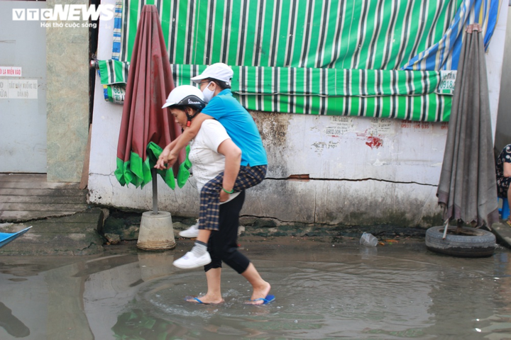 Ảnh: Triều cường liên tục đạt đỉnh, người Sài Gòn dùng xuồng đưa con đi học - 8