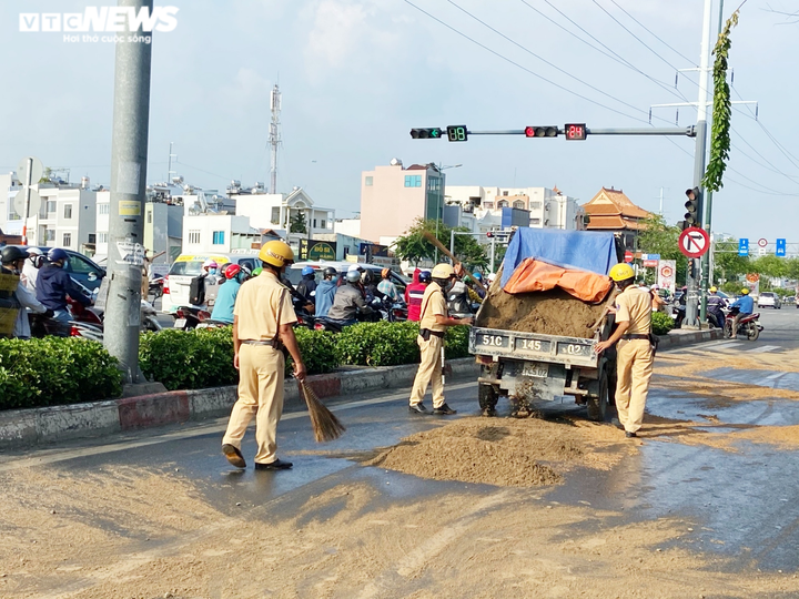 Ảnh: CSGT TP.HCM đội nắng gắt dọn đường, rải cát giúp dân đi không bị trượt ngã - 2