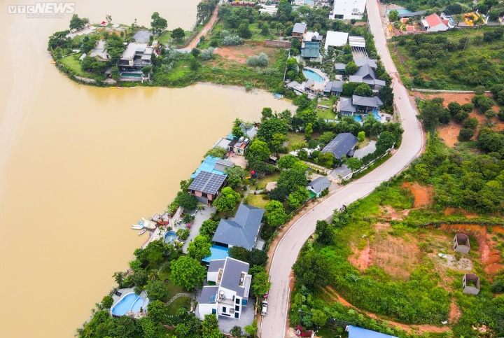 Hai bên đường ven hồ Đồng Đò là các công trình kiên cố, lưng tựa núi, mặt hướng hồ. Sát mép hồ, nhiều công trình đang xây dựng dở dang.