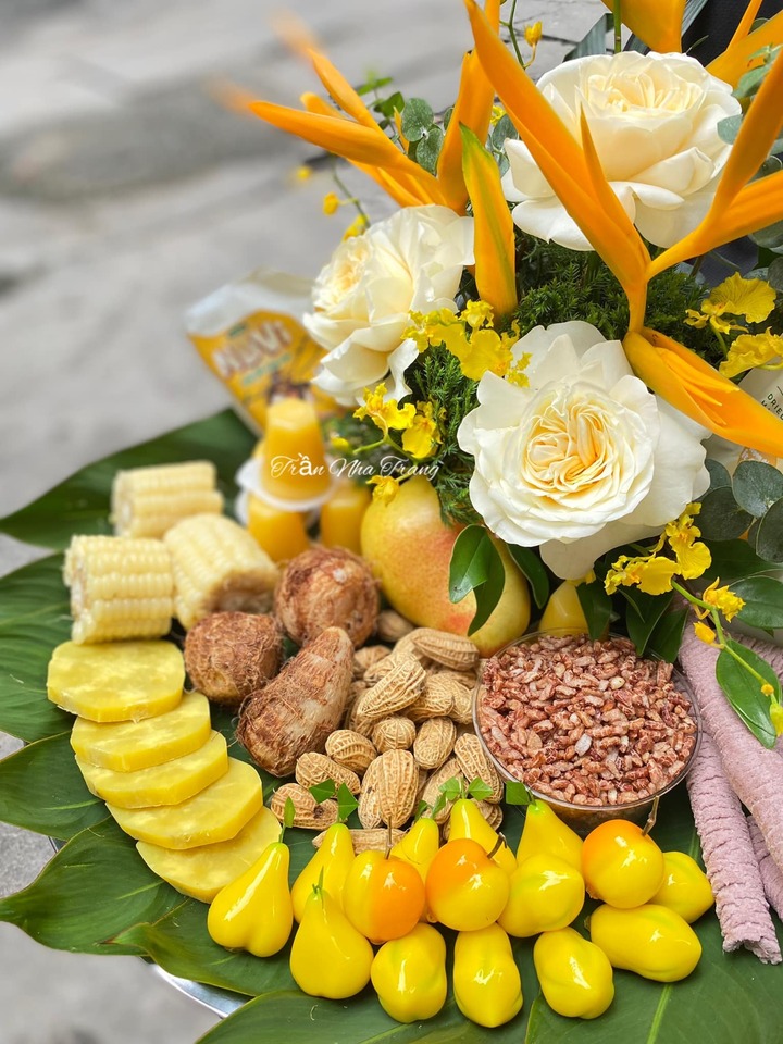 Mâm lễ tông vàng được bày lên chiếc lá xanh trông thật rực rỡ với các món quen thuộc như bỏng gạo lứt, ngô, khoai, sắn và lạc. (Ảnh: Trần Nha Trang)