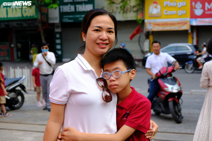 Chị Ngô Thị Huệ thao thức cả đêm, sáng nay chị dậy từ 5 giờ, di chuyển hơn 30km từ huyện Thanh Oai đưa con đến trường. "Con 10 tuổi, đáng lẽ đã học lớp 4 rồi nhưng vì trường hợp đặc biệt nên giờ con mới bắt đầu vào lớp 1. Con bị khiếm thị bẩm sinh, dù khó khăn tôi vẫn mong con được học hành, hòa nhập cùng các bạn", người mẹ này nói.