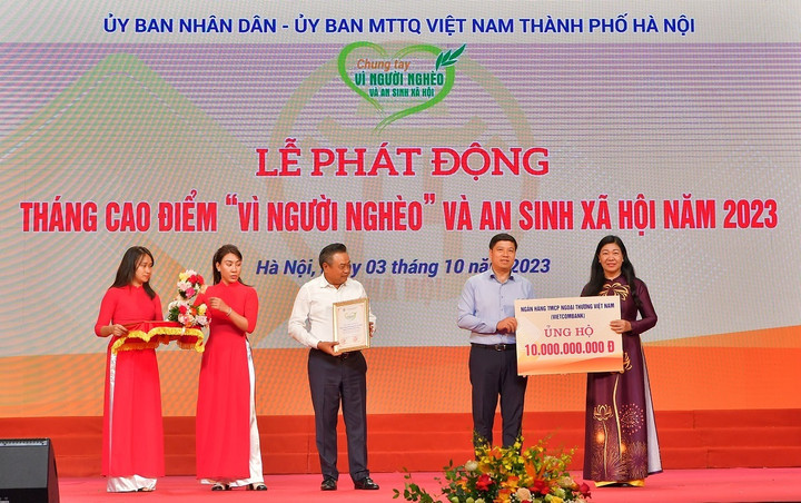 Ông Hồng Quang - Thành viên HĐQT kiêm Giám đốc Khối Nhân sự, Chủ tịch Công đoàn Vietcombank (thứ 2 từ phải sang) trao biển tượng trưng số tiền 10 tỷ đồng ủng hộ “Vì người nghèo” và an sinh xã hội TP Hà Nội năm 2023 và nhận biểu trưng ghi nhận.