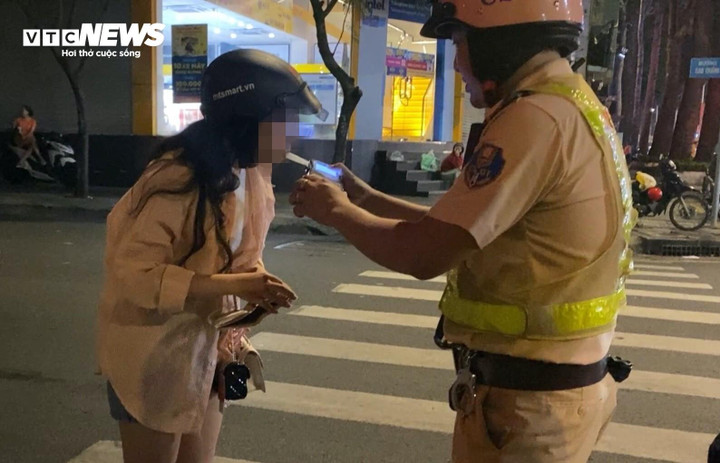 Lực lượng chức năng kiểm tra nồng độ cồn một nữ tài xế.