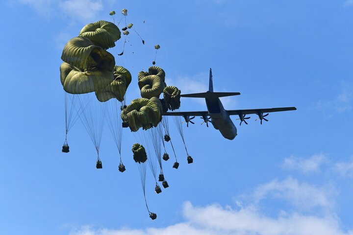 American paratroopers drop heavy packages from C-130 Hercules aircraft at the Frida Drop Zone in Pordenone, Italy.