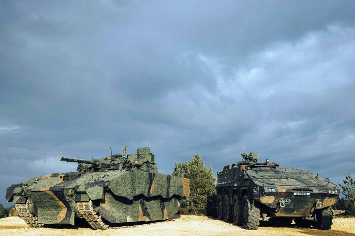 Ajax combat vehicle (left) and Boxer side by side during a demonstration of the British Army's capabilities on the training area at Camp Bovington, England.