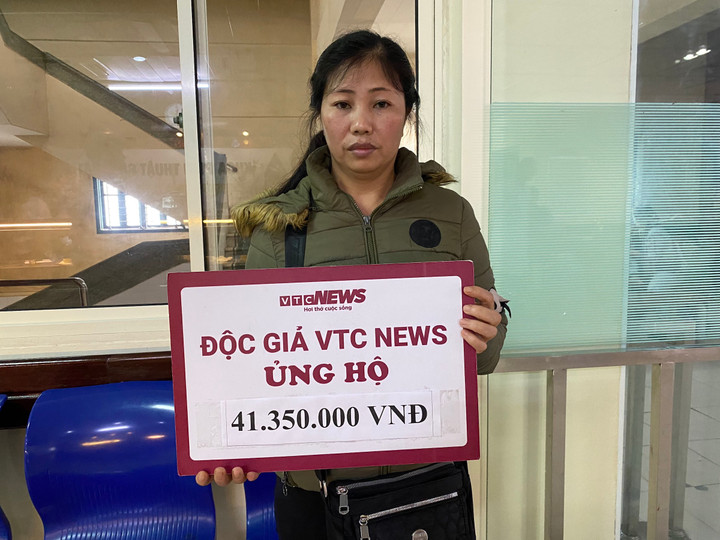Chị Hậu nhận số tiền ủng hộ của độc giả cho gia đình.