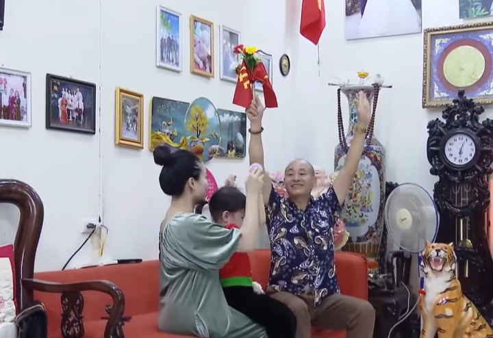 Bé Trâm được ông nội và mẹ giúp tập luyện tại nhà. (Ảnh: VTC1)