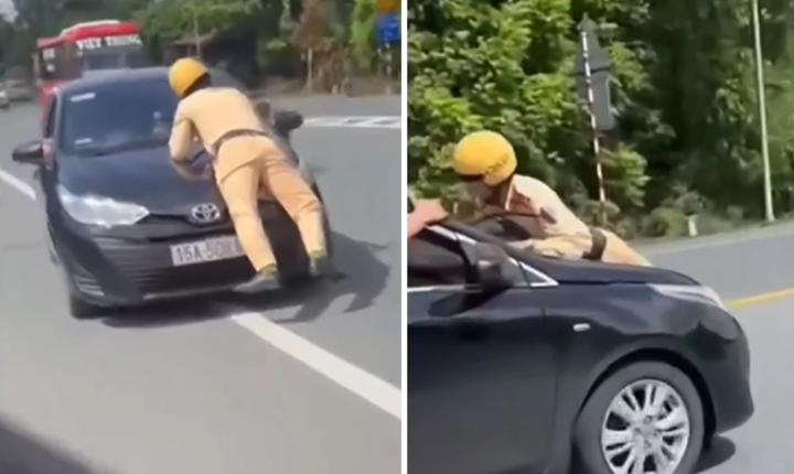 Cán bộ CSGT Hải Phòng bị hất lên nắp capo. (Ảnh cắt từ clip)