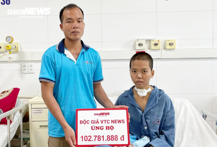 Anh Châu và con gái nhận số tiền ủng hộ từ bạn đọc Báo Điện tử VTC News. (Ảnh: Như Loan)