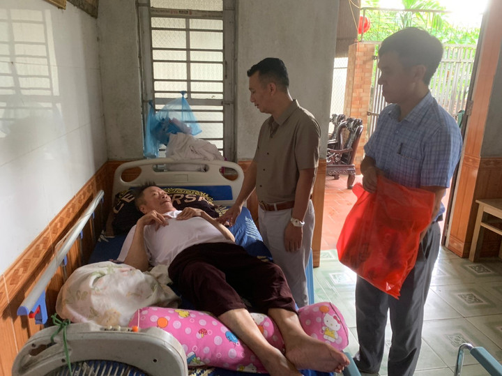 Ông Trần Thế Anh đến thăm và tặng quà cho ông Nguyễn Thư Vệ là thương binh tại thôn Áng Phao.