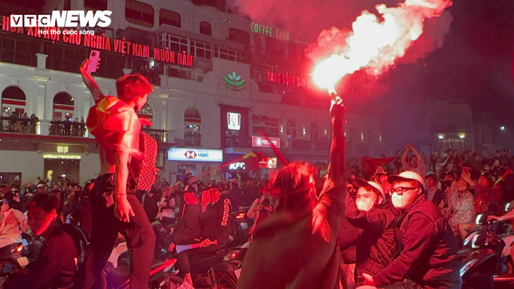 Người dân mang theo cờ Tổ quốc tràn xuống đường ăn mừng, nhiều người thậm chí còn đốt pháo sáng.