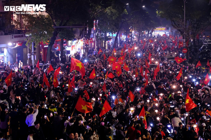 Người dân mang theo cờ Tổ quốc, kèn mừng tuyển Việt Nam thắng Thái Lan.