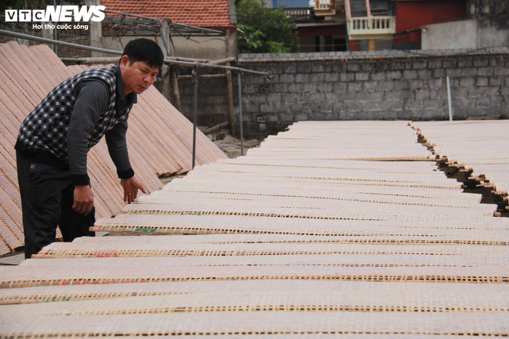 Ông Trần Văn Tường, chủ cơ sở sản xuất bánh đa nem Chúc Tường, Chủ tịch Hiệp hội Bánh đa nem làng Chều, đang phơi bánh đa nem.