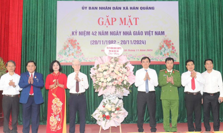 Ông Đặng Văn Tuấn, Chủ tịch UBND thị xã Quế Võ tặng hoa chúc mừng các nhà trường tại xã Hán Quảng.