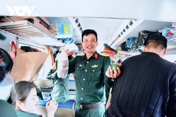 Một cán bộ quân đội vui vẻ khoe những món quà được trao tặng - hộp bánh bao, cốc cà phê và những gói bánh nho nhỏ gói ghém tình cảm của người dân địa phương.