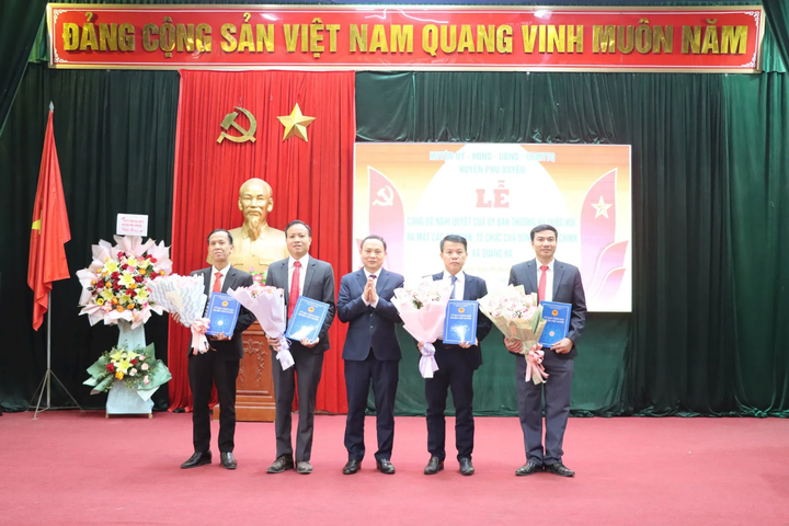 Lãnh đạo huyện Phú Xuyên trao quyết đinh và tặng hoa chúc mừng xã Quang Hà.