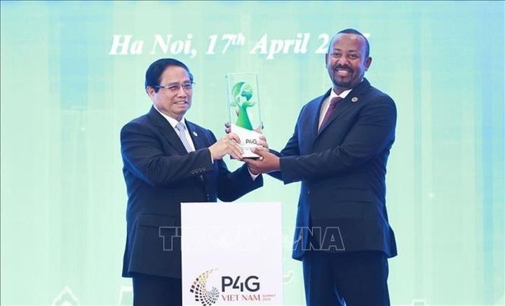 Thủ tướng Phạm Minh Chính trao biểu trưng đăng cai tổ chức Hội nghị thượng đỉnh Diễn đàn Đối tác vì Tăng trưởng xanh và Mục tiêu toàn cầu (P4G) lần thứ năm cho Thủ tướng Ethiopia Abiy Ahmed Ali. (Ảnh: Dương Giang/TTXVN)