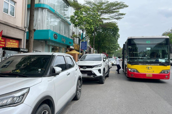 Ô tô đậu trên vỉa hè ảnh hưởng đến mỹ quan đô thị cũng như hoạt động kinh doanh của các chủ shop.