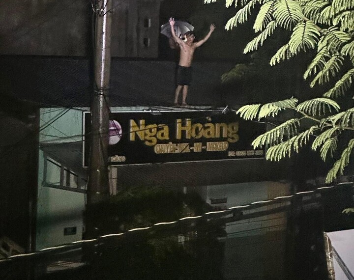 Hình ảnh người đàn ông giơ tay cầu cứu sự giúp đỡ để đưa người vợ đang mang thai của mình đến nơi an toàn khiến cộng đồng mạng xót xa.