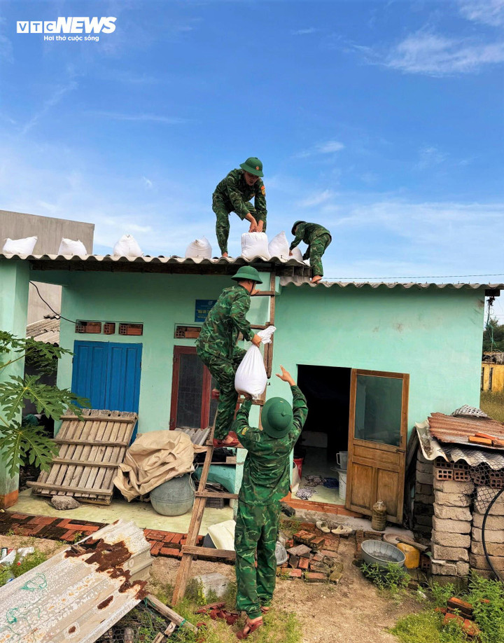 Bộ đội trên xã đảo Nhơn Châu giúp dân chằn chống nhà cửa trước giờ bão Kalmaegi đổ bộ.