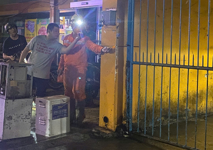 Nhân viên điện lực kiểm tra, phát hiện cửa sắt gần tủ điện có nối với một ổ cắm, phần tường và cửa sắt có dấu hiệu rò điện. (Ảnh: AH)