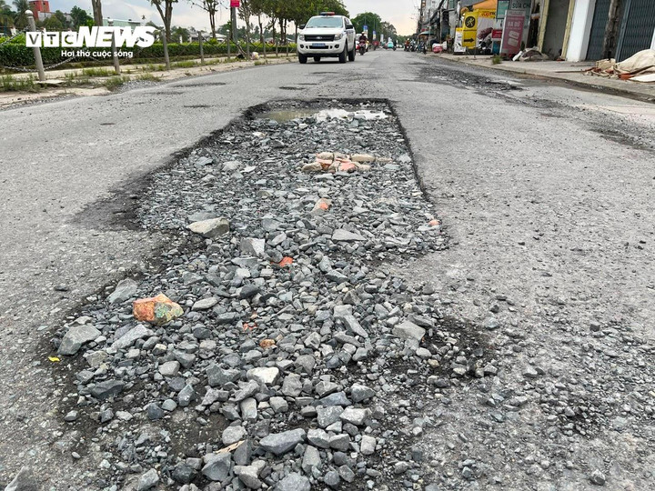 Không chỉ các tuyến nội ô, tại đường cạnh công viên Nguyễn Phương Danh (xã Phong Điền), mặt đường nứt nẻ, bong tróc sau nhiều đợt ngập, nguy cơ mất an toàn.