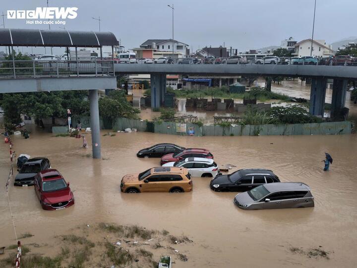 Lũ lên nhanh khiến người dân trở tay không kịp, đành bất lực chứng kiến ô tô bị ngập trong nước.