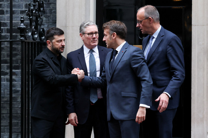 Tổng thống Pháp Emmanuel Macron bắt tay Tổng thống Ukraine Volodymyr Zelensky, bên cạnh Thủ tướng Đức Friedrich Merz và Thủ tướng Anh Keir Starmer, tại London, Anh, ngày 8/12/2025. (Ảnh: REUTERS/Isabel Infantes)